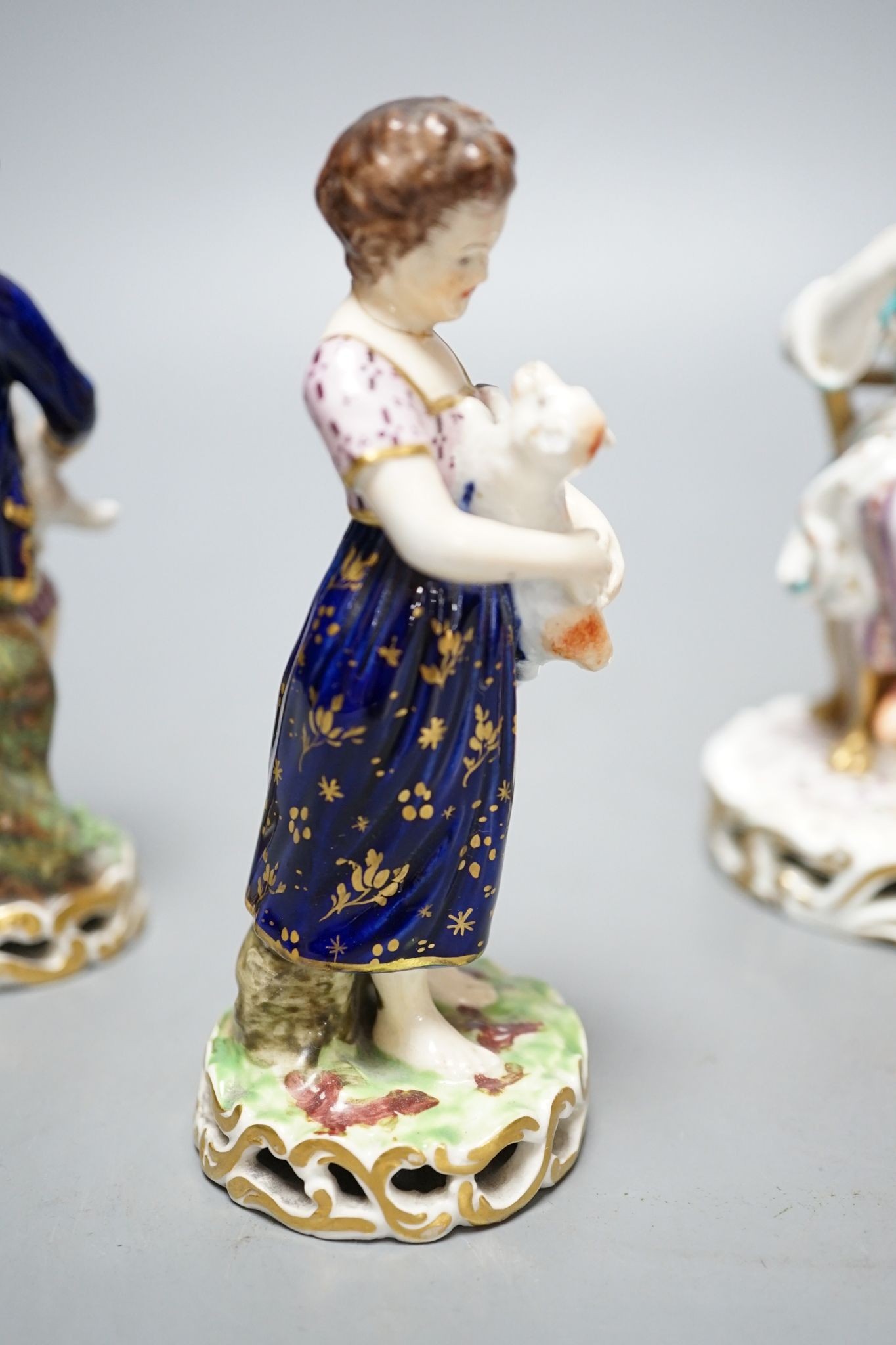 A Minton porcelain figure of a lady seated with a dog c.1830, a pair of Derby figures of a girl and a boy with a dog and a sheep, and a Bloor Derby vase